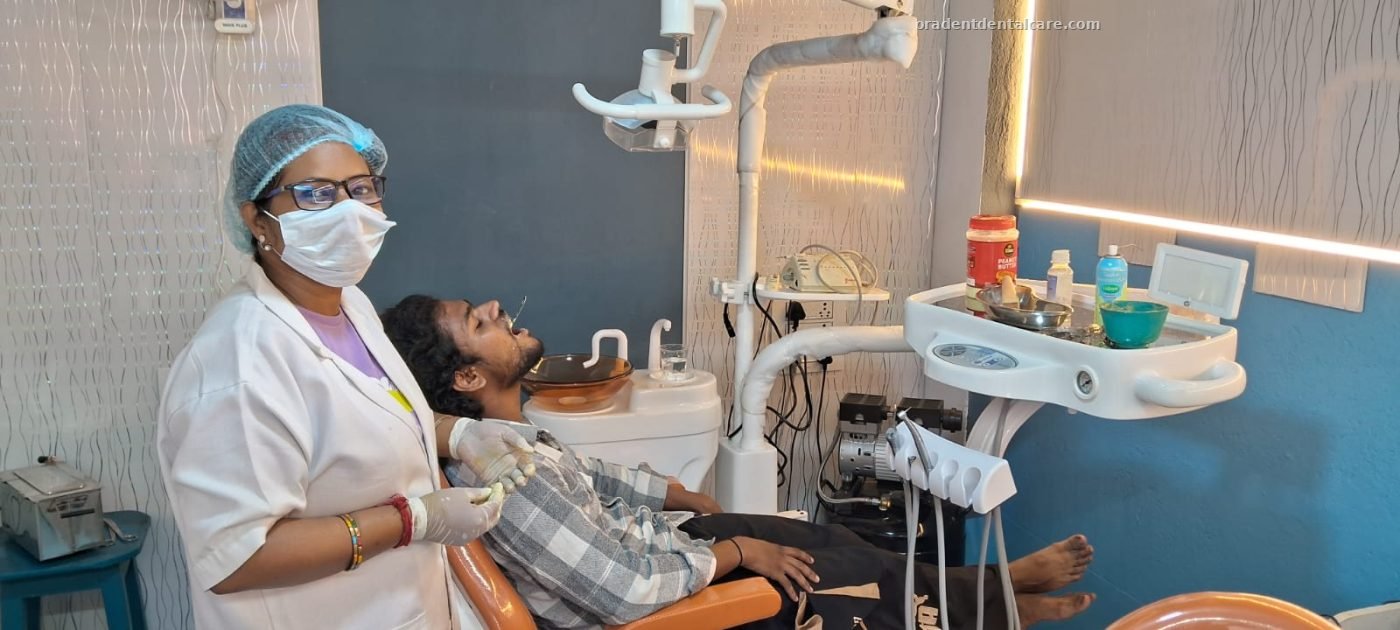 Patient reclined in the dental chair with the dentist alongside at ORADENT Dental Care