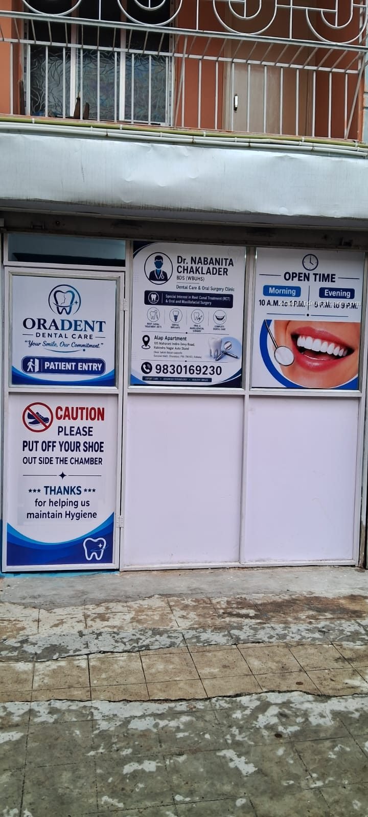 Entrance of ORADENT Dental Care in Parnasree, Behala, with the clinic name, opening times and patient-entry sign