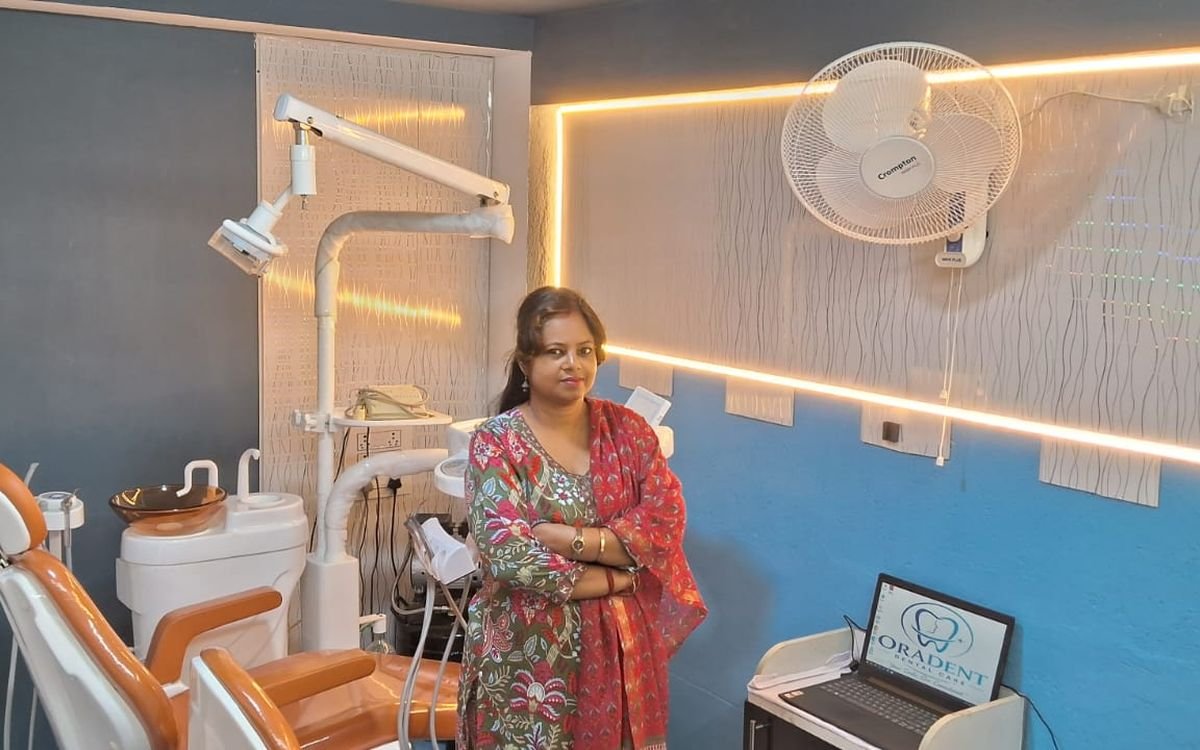 Dr. Nabanita Chaklader standing beside the dental chair in the ORADENT treatment room