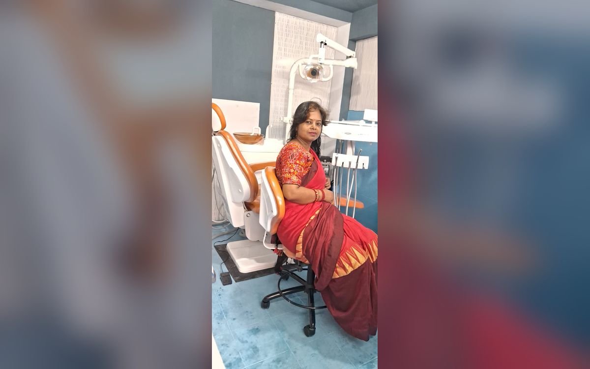 Dr. Nabanita Chaklader seated on the operator stool beside the dental chair